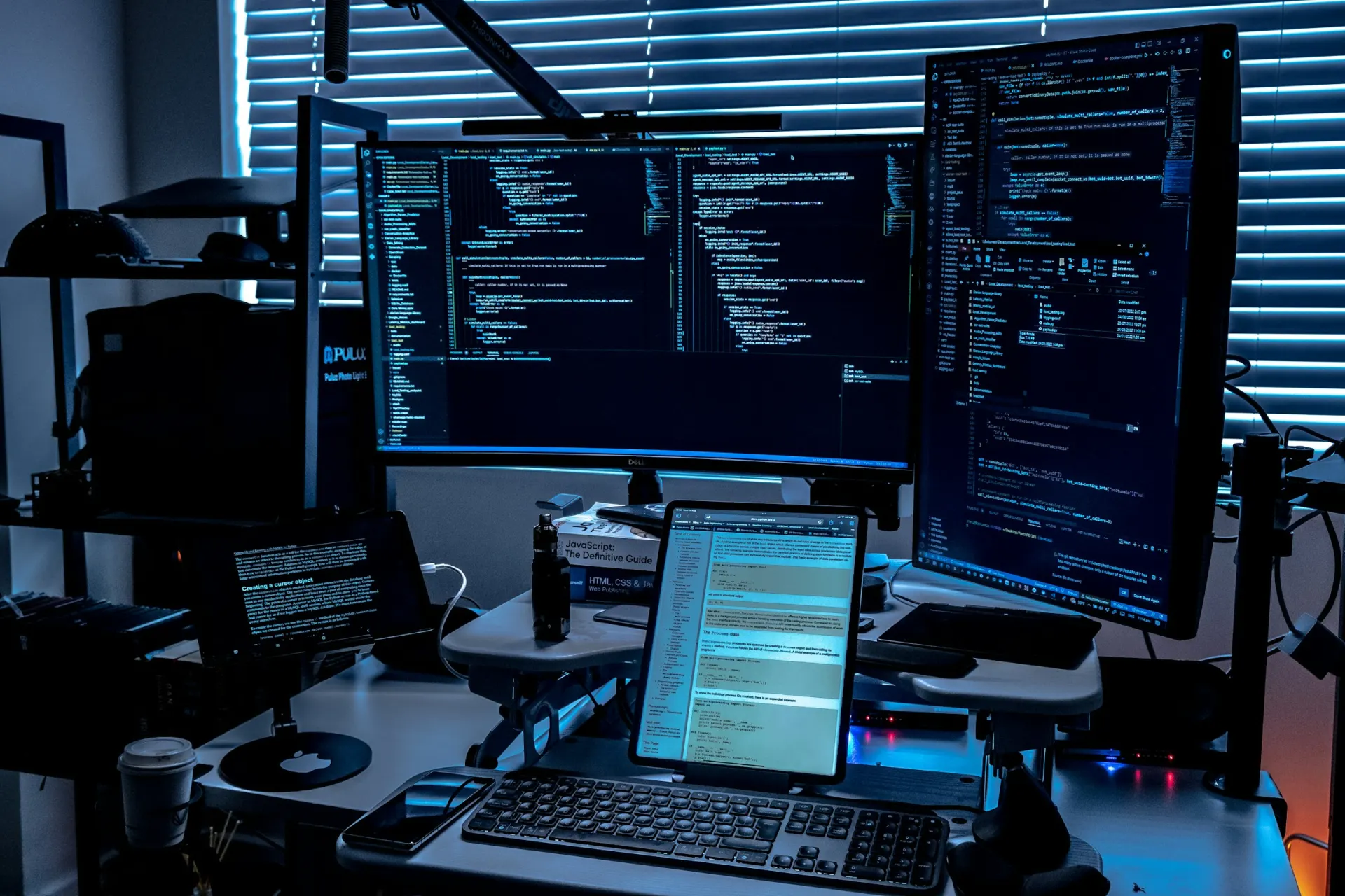 Security workstation with several monitors showing code and terminal output
